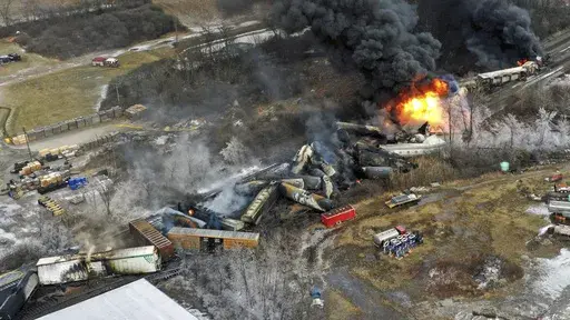In this photo taken with a drone, portions of a Norfolk Southern freight train that derailed the previous night in East Palestine, Ohio, remain on fire at mid-day, Feb. 4, 2023. (AP Photo/Gene J. Puskar, File)