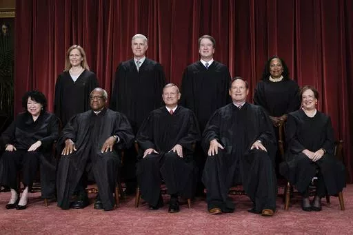 Members of the Supreme Court sit for a new group portrait following the addition of Associate Justice Ketanji Brown Jackson, at the Supreme Court building in Washington, Oct. 7, 2022. Bottom row, from left, Associate Justice Sonia Sotomayor, Associate Justice Clarence Thomas, Chief Justice of the United States John Roberts, Associate Justice Samuel Alito, and Associate Justice Elena Kagan. Top row, from left, Associate Justice Amy Coney Barrett, Associate Justice Neil Gorsuch, Associate Justice 
