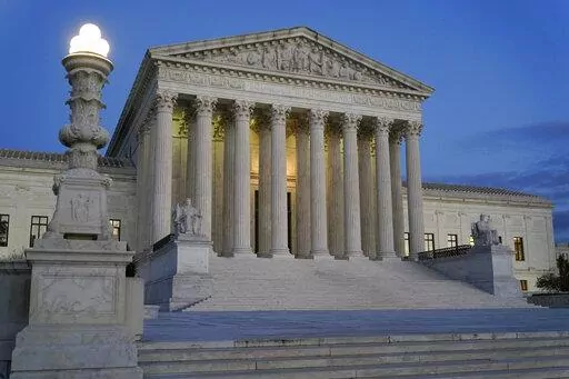 Light illuminates part of the Supreme Court building at dusk on Capitol Hill in Washington, Nov. 16, 2022. In courtrooms across America, defendants get additional prison time for crimes that juries found they didn’t commit. The Supreme Court is being asked, again, to put an end to the practice.(AP Photo/Patrick Semansky, File)