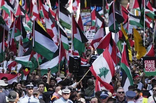 People march on the street as Pro-Palestinian supporters rally in Sydney, Sunday, Oct. 6, 2024. (AP Photo/Rick Rycroft)