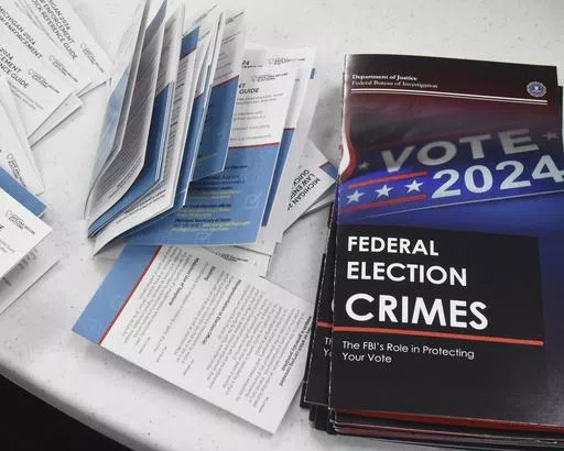 Educational materials provided by the Committee of Safe and Secure Elections are pictured at a conference with local election and law enforcement officials Wednesday, April 10, 2024, in Traverse City, Mich. A top concern for local election workers throughout the country this year is their own safety. The committee, formed after the 2020 presidential election, is traveling the country helping them prepare for what could lie ahead and making sure they are connected to local law enforcement. (AP Ph