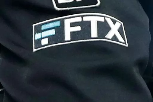 The FTX logo appears on home plate umpire Jansen Visconti's jacket at a baseball game with the Minnesota Twins on Tuesday, Sept. 27, 2022, in Minneapolis. The new CEO of the collapse cryptocurrency trading firm FTX, who oversaw Enron’s bankruptcy, said, Thursday, Nov. 17,  he has never seen such a “complete failure” of corporate control. John Ray III, in a filing with the U.S. bankruptcy court for the district of Delaware, said there was a “complete absence of trustworthy financial infor