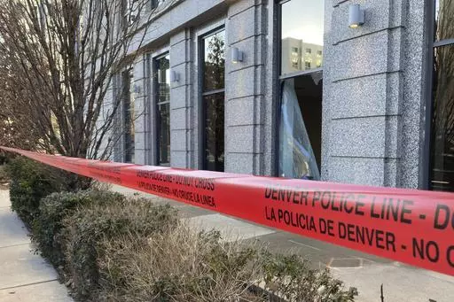 Police tape blocks the damage to large windows at the Colorado Supreme Court on Tuesday, Jan. 2, 2024 in Denver. Authorities say a man inflicted "extensive damage" to the building housing. (AP Photo/Colleen Slevin)