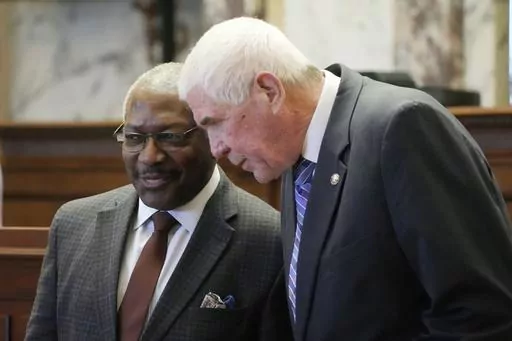 Senate Medicaid Committee Chairman Sen. Kevin Blackwell, R-Southaven, right, confers with Sen. John Horhn, D-Jackson, during debate over a proposal to expand Medicaid benefits before the Senate at the state Capitol in Jackson, Miss., Thursday, March 28, 2024. Senators debated the bill for nearly two hours before approving it. Legislators in both chambers will attempt to negotiate a compromise since the Senate version would insure fewer people and bring less federal money to the state. (AP Photo/