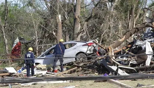 Wichita firefighters search what's left of John's Animal World on Saturday, April 30, 2022 in Andover, Kan.  A suspected tornado that barreled through parts of Kansas has damaged multiple buildings, injured several people and left more than 6,500 people without power. (Jaime Green /The Wichita Eagle via AP)