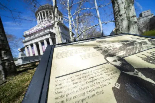 A informational plaque is displayed outside the perimeter of the General Grant National Memorial, Friday, April 22, 2022, in the Manhattan borough of New York. This month marks the 200th anniversary of the birth of Civil War hero and two-term president Ulysses S. Grant. (AP Photo/John Minchillo)