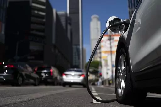 An electric vehicle is plugged into a charger in Los Angeles, Aug. 25, 2022. Ten electric or plug-in hybrid vehicles will be eligible for a $7,500 U.S. tax credit, while another seven could get $3,750 under new federal rules that go into effect on Tuesday, April 18, 2023. (AP Photo/Jae C. Hong, File)