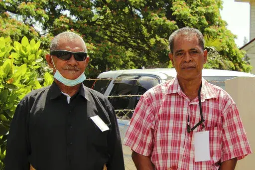 CORRECTS ID OF A PERSON AT RIGHT - Survivors Sulaki Kafoika, left, and Sione Vailea pose for a photo in Nukuʻalofa, Tonga on Feb. 22, 2022. Kafoika and Havea were on Mango Island in Tonga, one of the closest islands to the Jan. 15 volcanic eruption that was so huge it echoed around the world. Every single home on the island was destroyed by the tsunami that followed. (Aloma Johansson/Tonga Red Cross/IFRC via AP)