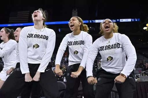 Colorado players, from left, Ally Fitzgerald, Mikayla Johnson and Shelomi Sanders, react after a 3-point basket against Oregon State during the second half of an NCAA college basketball game in the quarterfinals of the Pac-12 women's tournament, Thursday, March 2, 2023, in Las Vegas. When Deion Sanders arrived in Boulder to resurrect the University of Colorado's slumbering football program he not only brought his sons Sheduer, a star quarterback, and Shilo, a star safety, but also his youngest c