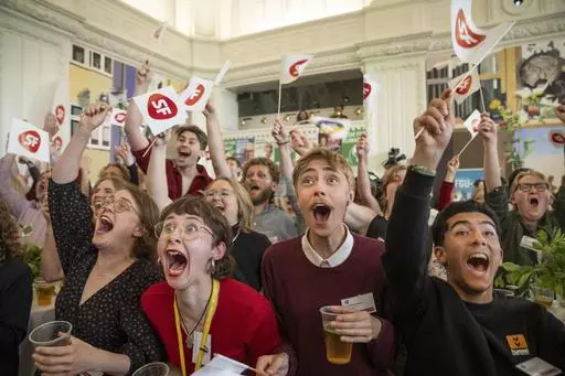 People cheer at the first exit poll at the Socialist People's Party for the election to the European Parliament at Christiansborg in Copenhagen, Sunday, June 9, 2024. (Bo Amstrup/Ritzau Scanpix via AP)