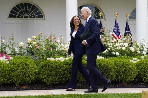 President Joe Biden walks with Vice President Kamala Harris after speaking on updated guidance on face mask mandates and COVID-19 response, in the Rose Garden of the White House, May 13, 2021, in Washington. Harris is capping off a controversial first year in office, creating history as the first woman of color in her position while fending off criticism and complaints over her focus and agenda. While she’s sought to make the office her own, Harris has struggled at times with the constraints o