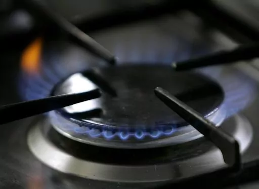 A gas-lit flame burns on a natural gas stove on Jan. 11, 2006. The Republican-controlled House is taking up legislation that GOP lawmakers say would protect gas stoves from over-zealous government regulators. (AP Photo/Thomas Kienzle, File)