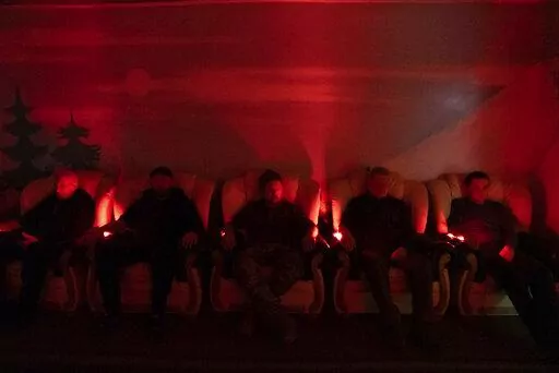 Ukrainian soldiers undergo laser therapy at a rehabilitation center in Kharkiv region, Ukraine, Friday, Dec. 30, 2022. The relentless 10-month war has prompted a local commander to transform an old soviet-era sanatorium into a recovery center for servicemen to treat both mental and physical ailments. (AP Photo/Vasilisa Stepanenko)
