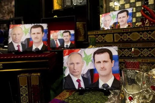 Photos on porcelain decorated with the images of Russian President Vladimir Putin and Syrian President Bashar Assad are displayed in a souvenir shop in Damascus, Syria, April 18, 2016. Political observers say Russia’s brazen Syria intervention emboldened Putin, giving him a renewed Middle East foothold and helped pave the way for his current attack on Ukraine. (AP Photo/Hassan Ammar, File)