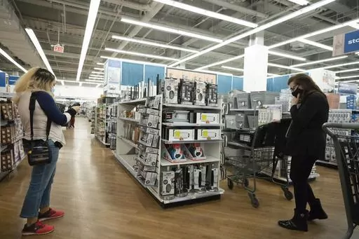 In this March 25, 2021 file photo, shoppers browse in New York. Women often pay more for goods and services, but it doesn’t have to be that way. Shopping experts say that by opting for gender-neutral personal care products, consumers can sometimes avoid what’s been dubbed the “pink tax.” (AP Photo/Mark Lennihan, File)