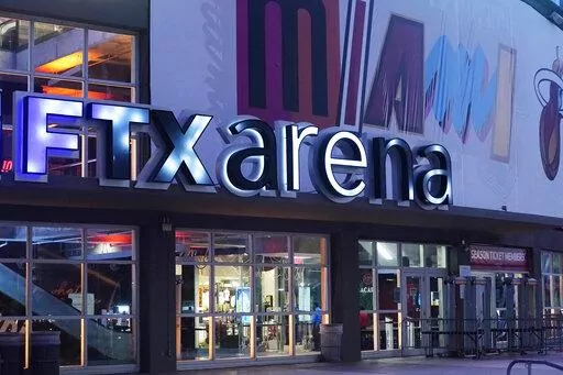 Signage for the FTX Arena, where the Miami Heat basketball team plays, is illuminated Saturday, Nov. 12, 2022, in Miami. Collapsed cryptocurrency trading firm FTX confirmed there was “unauthorized access” to its accounts, hours after the company filed for Chapter 11 bankruptcy protection Friday, Nov. 11.    (AP Photo/Marta Lavandier)