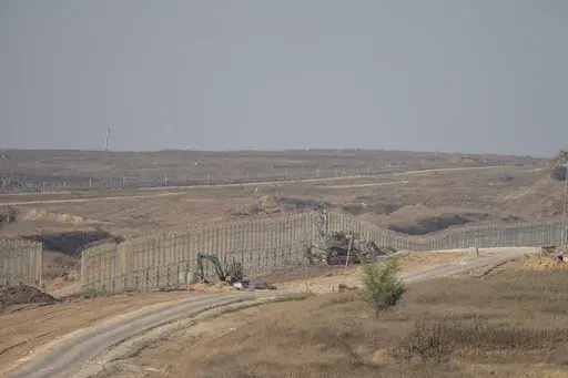 Israeli army bulldozers are seen near the Gaza Strip border, in southern Israel, Thursday, June 13, 2024. Israel's military said Saturday, June 15, that eight soldiers were killed in southern Gaza in the deadliest attack on Israeli forces in months. (AP Photo/Ohad Zwigenberg, File)