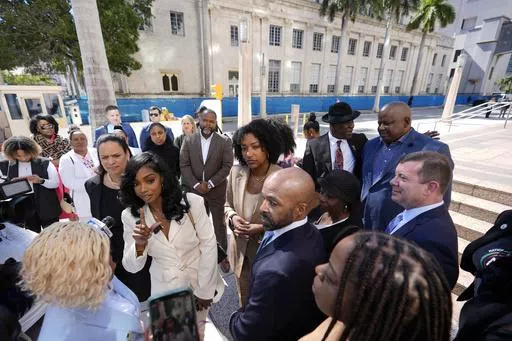 Co-founders and CEOs of The Fearless Fund Arian Simone, center left, and Ayana Parsons, center right, speak to journalists outside federal court in Miami, on Jan. 31, 2024. A U.S. federal court of appeals panel suspended the venture capital firm's grant program for Black women business owners, ruling that a conservative group is likely to prevail in its lawsuit claiming that the program is the discriminatory. (AP Photo/Rebecca Blackwell, File)