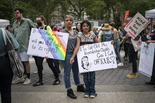 Amnet Ramos, 44, and her daughter, Inaia Hernandez, 12, stand for a portrait during a protest in Manhattan on Saturday, May 14, 2022, in New York where generations of women came together for a protest against the U.S. Supreme Court's anticipated ruling overturning Roe v. Wade. Ramos has protested since the Trump administration, and the threat to abortion rights has steeled her resolve to be heard - and that of her daughter. (AP Photo/Wong Maye-E)