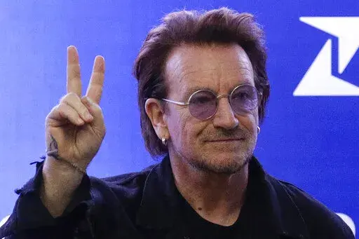 U2 singer Bono gestures as he attends the launching of the first blood by drone delivery service in the country at the Philippine Red Cross headquarters in suburban Mandaluyong, east of Manila, Philippines on Tuesday Dec. 10, 2019. Bono opened his book tour for his bestselling "Surrender: 40 Songs, One Story," on Wednesday, Nov. 2, 2022, to thousands of screaming fans at Manhattan's Beacon Theatre. (AP Photo/Aaron Favila, File)