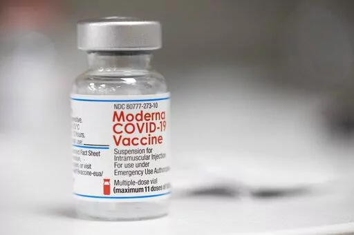 A vial of the Moderna COVID-19 vaccine is displayed on a counter at a pharmacy in Portland, Ore., Monday, Dec. 27, 2021. U.S. regulators have granted full approval to Moderna’s COVID-19 vaccine after reviewing additional data on its safety and effectiveness. The decision Monday, Jan. 31, 2022 by the Food and Drug Administration comes after many tens of millions of Americans have already received the shot under its original emergency authorization. Full approval means FDA has completed the same