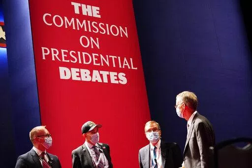 Officials from the Commission on Presidential Debates gather near the stage before the start of the second and final presidential debate, Oct. 22, 2020, at Belmont University in Nashville, Tenn. The Republican National Committee says it is planning a rules change that would force presidential candidates seeking the party’s nomination to sign a pledge saying they will not participate in any debates sponsored by the Commission on Presidential Debates.  (AP Photo/Patrick Semansky, File)