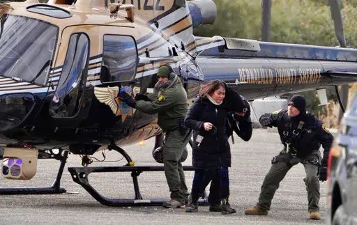 A passenger is rescued after a Sandia Peak Tramway car was stranded overnight on New Year's Eve on Saturday, Jan. 1, 2022 in Albuquerque, N.M.  A Bernalillo County Fire Department spokesman said 16 of the stranded people were rescued as of Saturday afternoon as rescue operations continued. The spokesman said those aboard the car when it got stuck at 10 p.m. Friday were all employees of the Sandia Peak Aerial Tramway or a mountaintop restaurant.  (Roberto E. Rosales /The Albuquerque Journal via A
