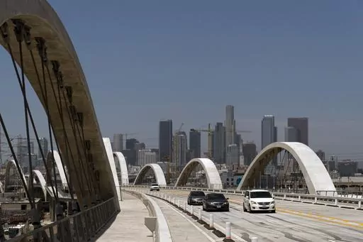 Cars move along the 6th Street Viaduct in Los Angeles, Wednesday, July 27, 2022. Police say a 17-year-old boy slipped and fell to his death this weekend while climbing a Los Angeles bridge in an apparent social media stunt. (AP Photo/Jae C. Hong, File)