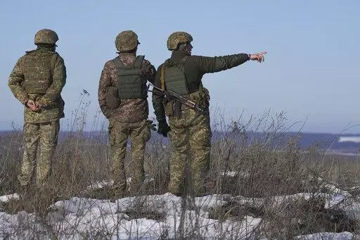 Ukrainian servicemen survey the impact areas from shells that landed close to their positions during the night on a front line outside Popasna, Luhansk region, eastern Ukraine, Monday, Feb. 14, 2022. Russia's Foreign Minister Sergey Lavrov advised President Vladimir Putin on Monday to keep talking with the West on Moscow's security demands, a signal from the Kremlin that it intends to continue diplomatic efforts amid U.S. warnings of an imminent Russian invasion of Ukraine.(AP Photo/Vadim Ghirda