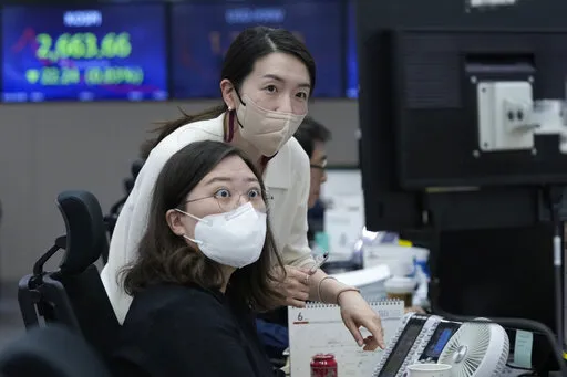 Currency traders watch monitors at the foreign exchange dealing room of the KEB Hana Bank headquarters in Seoul, South Korea, Thursday, June 2, 2022. Asian shares declined Thursday, echoing a retreat on Wall Street as investors fretted about higher interest rates and rising coronavirus cases in parts of the region. (AP Photo/Ahn Young-joon)