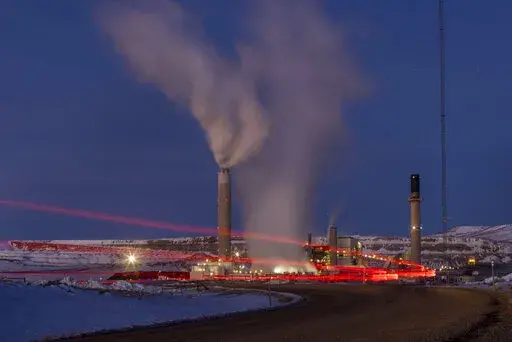 Taillights trace the path of a motor vehicle at the Naughton Power Plant, Jan. 13, 2022, in Kemmerer, Wyo. The Supreme Court decision June 30, restricting the authority of the Environmental Protection Agency may mean continued pollution from power plants in states that are not switching to cleaner energy. But many states are switching and experts say they'll remain free to keep cleaning up their electrical grids under the new decision. (AP Photo/Natalie Behring, File)