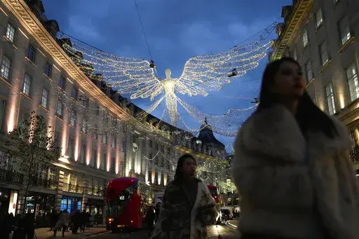 People walk on Regent Street, in London, on Nov. 17, 2022. Britain’s economy shrank in the three months through October, confirming the toll that rampant inflation and rising interest rates are having on business and industry. (AP Photo/Kin Cheung, File)