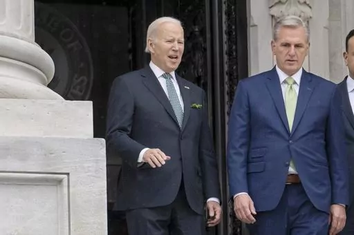 President Joe Biden talks with House Speaker Kevin McCarthy, R-Calif., as he departs the Capitol following the annual St. Patrick's Day gathering, in Washington, March 17, 2023. Facing the risk of a federal government default as soon as June 1, President Joe Biden has invited the top four congressional leaders to a White House meeting on May 9 for talks. It’s the first concrete step toward negotiations on averting a potential economic catastrophe, but there’s a long way to go: Biden and Repu