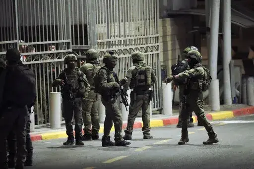 Israeli security forces patrol next to the scene of a shooting attack near the Shuafat refugee camp in Jerusalem, Saturday, Oct. 8, 2022. Israeli police say armed assailants have opened fire at an Israeli military checkpoint in east Jerusalem, seriously wounding at least two people. (AP Photo/Mahmoud Illean)