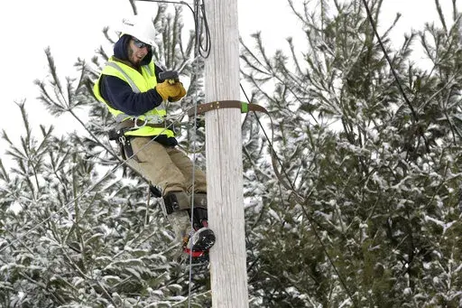 Trevor Haskins, of Waitsfield and Champlain Valley Telecom, works to run fiber fiber optic cable to a home in Concord, Vt., Thursday Feb. 10, 2022. The nationwide need to connect homes and businesses to high-speed broadband services was highlighted by the COVID-19 pandemic and officials say that while there is lots of money available, supply and labor shortages are making the expansion a challenge. (AP Photo/Wilson Ring)