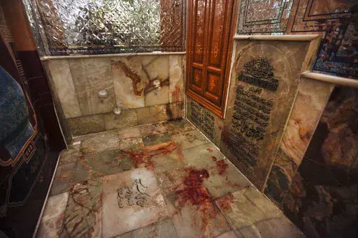 Bullet holes on the wall and blood on the ground are seen after gunmen attacked the Shah Cheragh shrine in the southern city of Shiraz, Iran, Wednesday, Oct. 26, 2022. Gunmen attacked the major Shiite holy site in Iran on Wednesday, killing at least 15 people and wounding dozens. The attack came as protesters elsewhere in Iran marked a symbolic 40 days since a woman's death in custody ignited the biggest anti-government movement in over a decade. (Mohammadreza Dehdari/Iranian Students' News Agen