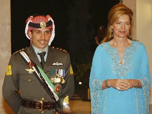Jordan's then Crown Prince Hamzeh, left, with his mother then Queen Noor, during his wedding ceremony in Amman, Jordan, May 27, 2004. Prince Hamzeh, the half-brother of Jordan’s king, posted a letter on his official Twitter account on Sunday, April 3, 2022, relinquishing his princely title, a year after a rare palace feud saw him placed under house arrest. (AP Photo/Hussein Malla, File)