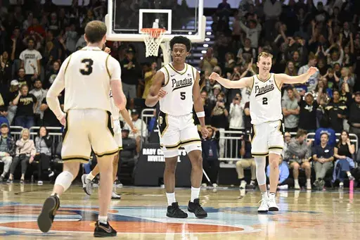 Purdue players celebrate during the second half of an NCAA college basketball game against Mississippi, Friday, Nov. 29, 2024, in San Diego. (AP Photo/Denis Poroy)