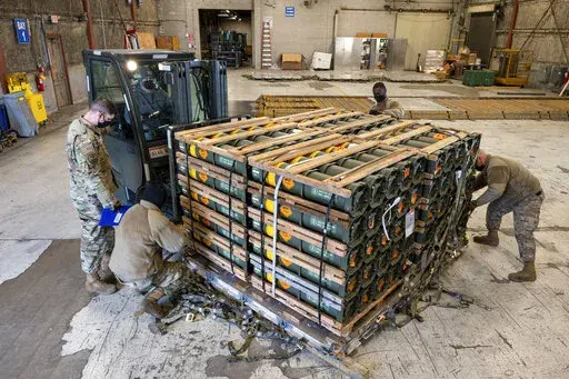 In this image provided by the U.S. Air Force, Airmen and civilians from the 436th Aerial Port Squadron palletize ammunition, weapons and other equipment bound for Ukraine during a foreign military sales mission at Dover Air Force Base, Del., on Jan. 21, 2022. Western weaponry pouring into Ukraine helped blunt Russia's initial offensive and seems certain to play a central role in the approaching battle for Ukraine's contested Donbas region. Yet the Russian military is making little headway haltin