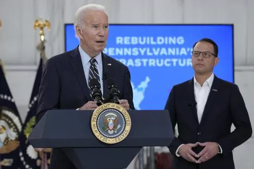 Pennsylvania Gov. Josh Shapiro, right, listens as President Joe Biden speaks about the Interstate 95 highway collapse after an aerial tour of the site at Philadelphia International Airport in Philadelphia, Saturday, June 17, 2023. (AP Photo/Manuel Balce Ceneta, File)
