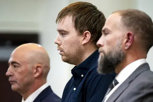 Travis Reinking, center, reacts as the verdict is read during day five of Reinking's murder trial at the Justice A.A. Birch Building in Nashville, Tenn., Friday, Feb. 4, 2022. A jury found Reinking guilty of first-degree murder in the deaths of four people at a Waffle House in 2018. (Andrew Nelles/The Tennessean via AP, Pool)