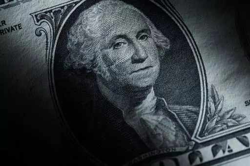 The likeness of George Washington is seen on a U.S. one dollar bill, Monday, March 13, 2023, in Marple Township, Pa. After years of paying low rates for savers, banks are finally offering better interest on deposits. Moving your savings around by opening a new account and closing an old one can seem like a hassle, but it's a use of time that can pay off. (AP Photo/Matt Slocum)