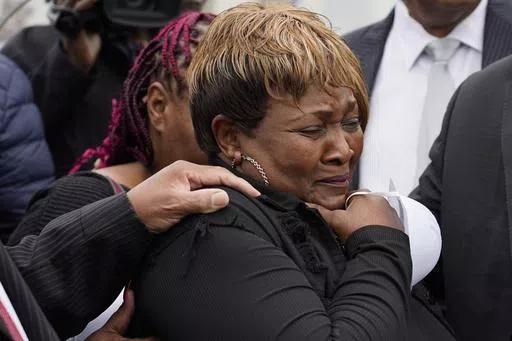 Bettersten Wade, mother of Dexter Wade, who died after being hit by a Jackson, Miss., police SUV driven by an off-duty officer, cries after her son's body is exhumed from a pauper's cemetery in Raymond, Miss., Nov. 13, 2023. A judge on Friday, May 31, 2024, ordered the enforcement of a lawsuit settlement between the city of Jackson and the family of 62-year-old George Robinson, who died after police officers pulled him from a car while searching for a murder suspect in 2019. Wade is Robinson's s