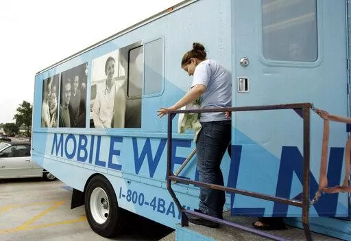 Leslie Rosas, 15, leaves the mobile health clinic with her one-month-old daughter Cielo Angela Carrizalez after their checkup at the mobile health clinic in Garland, Texas, on April 11, 2006. The clinic is just one way of helping teen mothers in Texas. States with some of the nation's strictest abortion laws are also some of the hardest places to have and raise a healthy child, especially for the poor, according to an analysis of federal data by The Associated Press. (AP Photo/LM Otero)