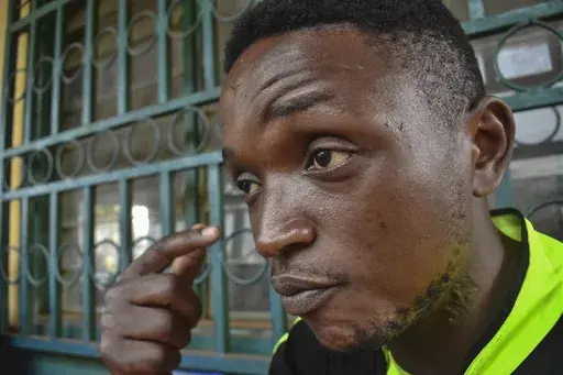 Ateasong Belts Tajoah shows a bullet scar on his neck during an interview with The Associated Press in Dschang, Cameroon, Friday, Dec. 1, 2024. (AP Photo/Robert Bociaga)