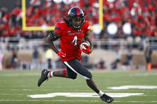 FILE -Texas Tech's SaRodorick Thompson (4) runs to score a touchdown during the second half of an NCAA college football game against Texas Tech, Saturday, Nov. 13, 2021, in Lubbock, Texas. Ole Miss looks to end a disappointing season on a positive note Wednesday night, Dec. 28, 2022 when the Rebels meet Texas Tech in the Texas Bowl. Texas Tech has a talented running back duo in SaRodorick Thompson and Tahj Brooks. Thompson leads Texas Tech with 670 yards rushing. (AP Photo/Brad Tollefson, File)