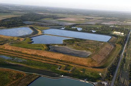 This aerial photo taken from an airplane shows a reservoir near the old Piney Point phosphate mine on April 3, 2021, in Bradenton, Fla. The polluted leftovers of Florida's phosphate fertilizer mining industry, more than 1 billion tons in “stacks” that resemble enormous ponds, are at risk for leaks or other contamination triggered by Hurricane Ian, said environmental groups Tuesday, Sept. 27, 2022. (Tiffany Tompkins/The Bradenton Herald via AP, File)