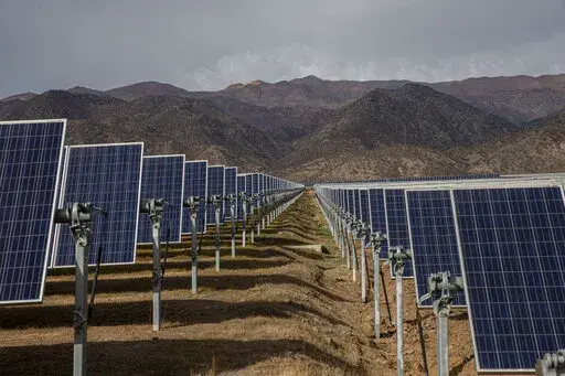 Solar panels stand in the Quilapilún solar energy plant, a joint venture by Chile and China, in Colina, Chile, Aug. 20, 2019. Chile has long held itself out as a global leader in the fight against climate change and now nearly 22% of Chile’s power is generated by solar and wind farms, putting it far ahead of both the global average, 10%. (AP Photo/Esteban Felix, File)