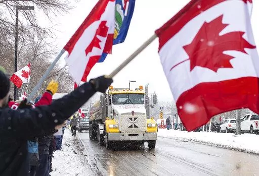 People gather in protest against COVID-19 mandates and in support of a protest against COVID-19 restrictions taking place in Ottawa, in Edmonton, Alberta, Saturday, Feb. 5, 2022. (Jason Franson/The Canadian Press via AP)
