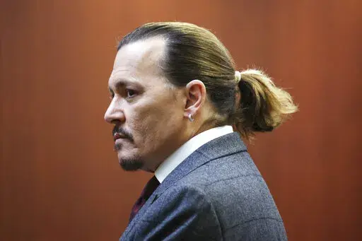 Actor Johnny Depp arrives in the courtroom at the Fairfax County Circuit Court in Fairfax, Va., Thursday, April 28, 2022. Actor Johnny Depp sued his ex-wife actor Amber Heard for libel in Fairfax County Circuit Court after she wrote an op-ed piece in The Washington Post in 2018 referring to herself as a "public figure representing domestic abuse." (Michael Reynolds/Pool Photo via AP)